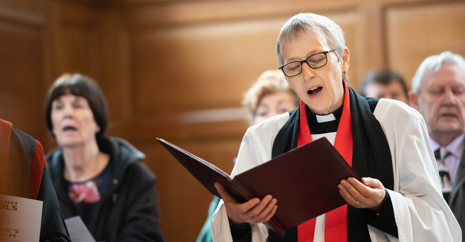 Rector singing hymn in a service