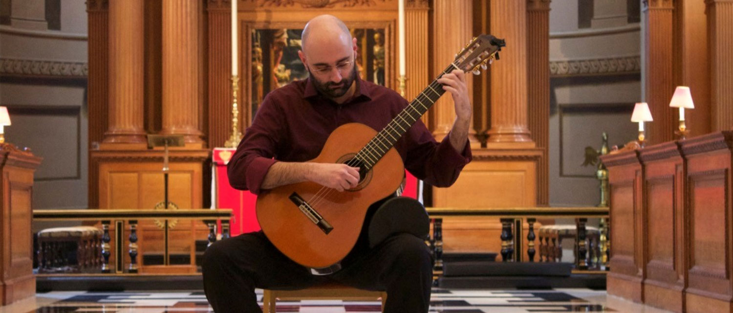 Guitarist Stelios Kyriakidis playing in front of the altar of St Bride's