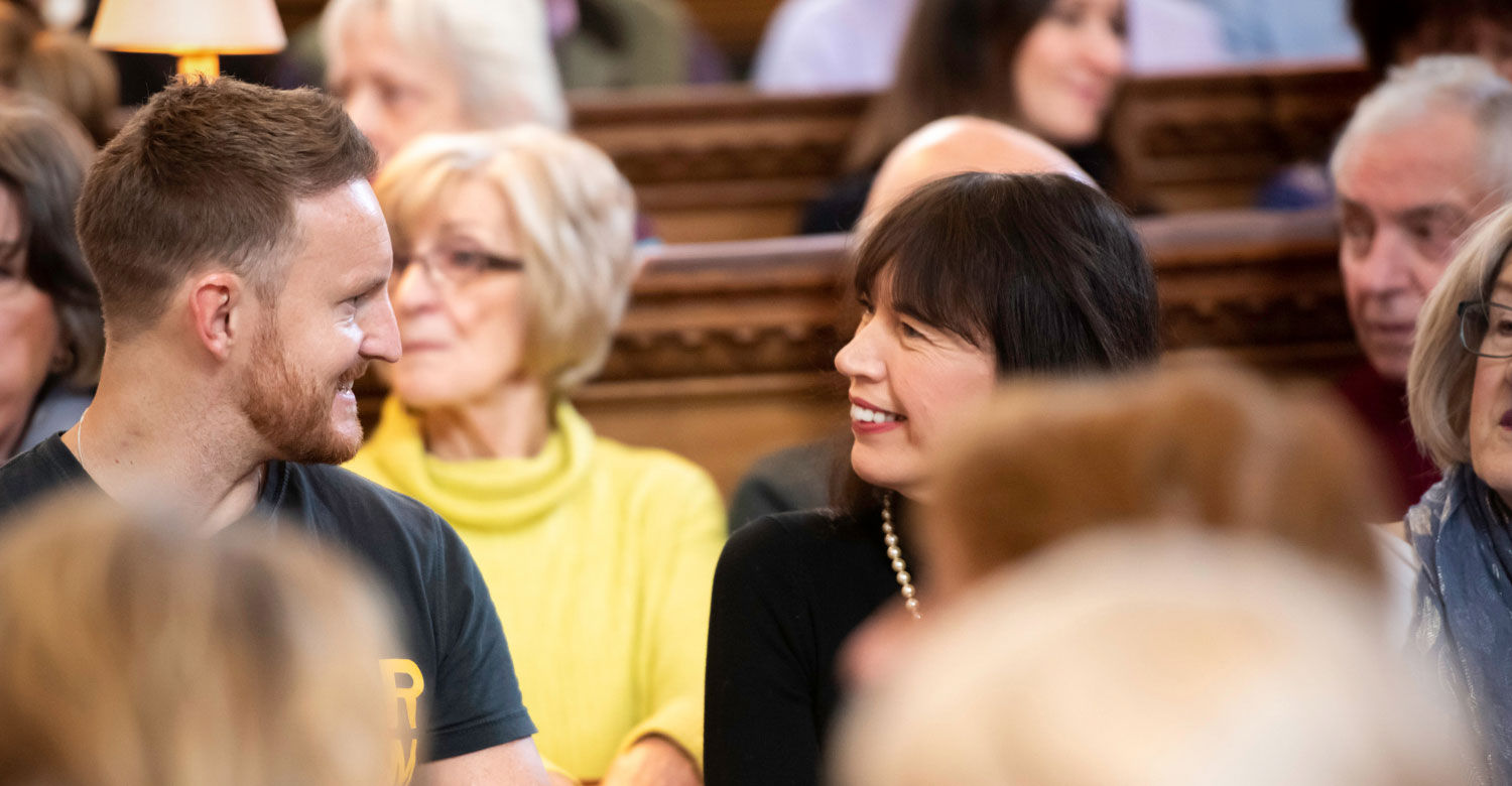 Congregation members talking in pew before service