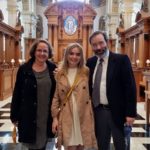 US friends Angelynne Caroline and Ed Hinson in front of the oak reredos at St Bride's