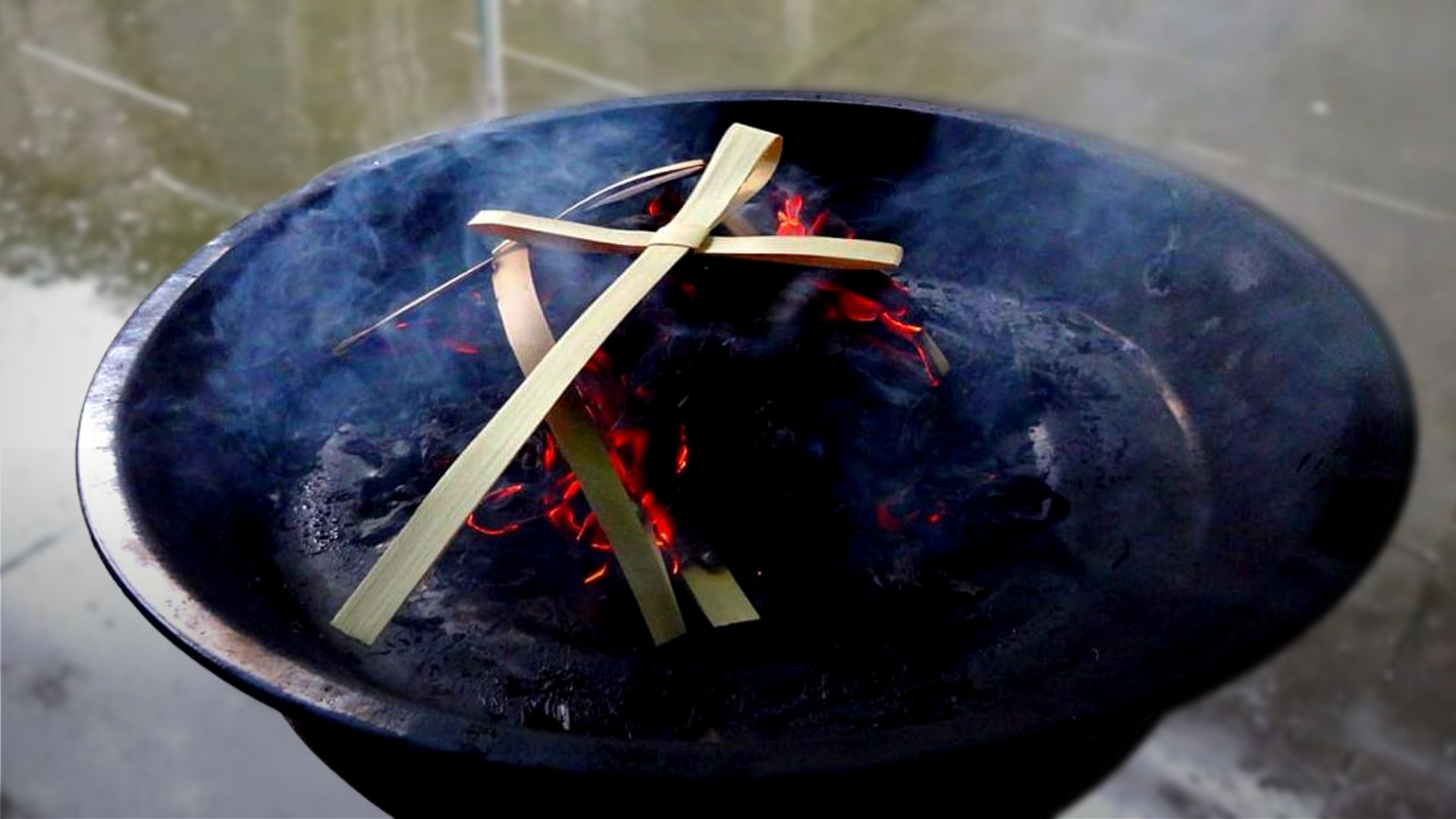 Palm Sunday crosses turing to ash on burning coals