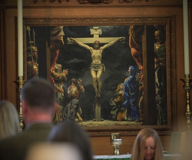 Painting of the Crucifixion by Glyn Jones and people at the altar