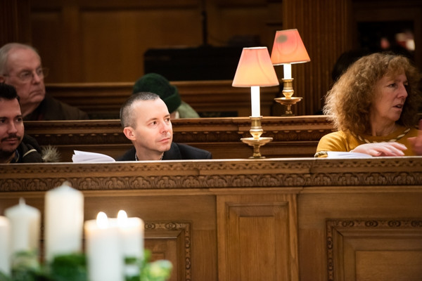 People sitting in church pew listening to lecture