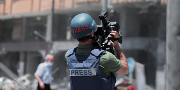 Palestinian journalist records the rubble of the severely damaged Al-Jawhara Tower in Gaza City