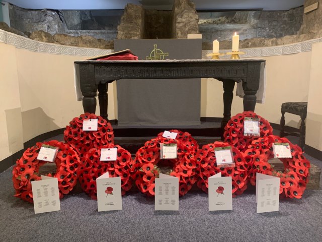 Poppy wreaths in front of Crypt altar at St Bride's